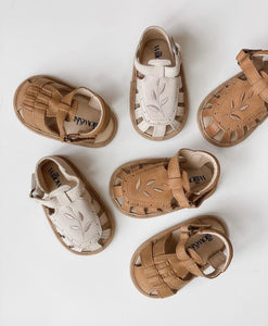 Baby Willow Sandal, made from soft wax leather, featuring a Willow leaf embroidery, soft suede soles, and a velcro strap, with a closed-in toe and heel design, perfect for both boys and girls.